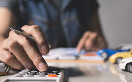 Close-up of man using smart phone on table