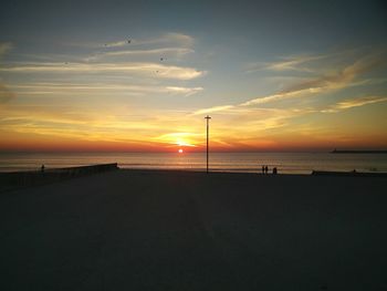 Scenic view of beach against sky during sunset