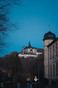 Buildings against blue sky at dusk