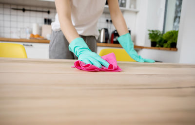 Midsection of woman standing at home