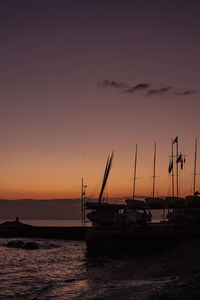 Silhouette sailboats on sea against sky during sunset