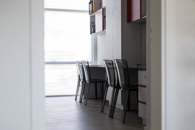 Empty chair on table by window at home