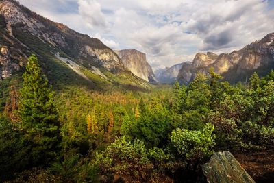 Scenic view of mountains against cloudy sky