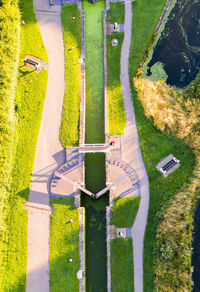 High angle view of road amidst field and trees in city