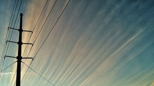 Low angle view of electricity pylon against sky