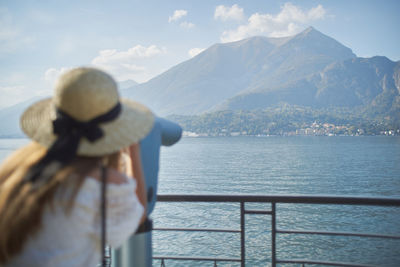 Rear view of man looking at sea against sky