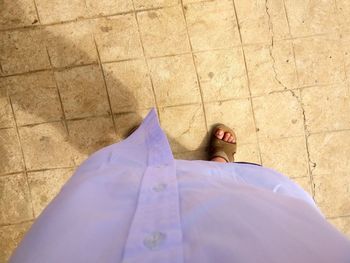 Low section of woman standing on tiled floor