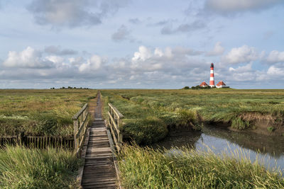 View of lighthouse on field against sky