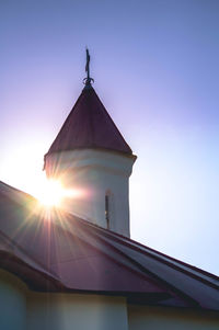 Low angle view of building against sky on sunny day