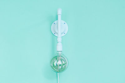 Close-up of lamp against blue background