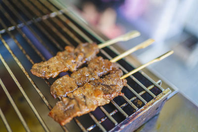 Close-up of meat on barbecue grill