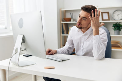 Young businesswoman working at desk in office