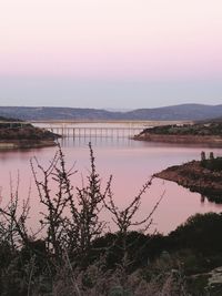 Scenic view of lake against sky during sunset