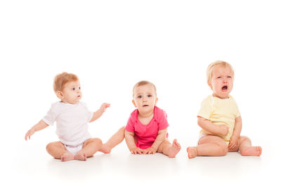 Portrait of cute baby boy against white background