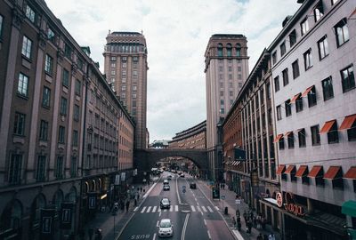 Traffic on road amidst buildings in city