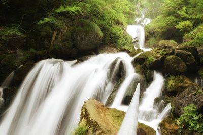 Low angle view of waterfall and rock