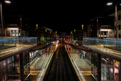 Railroad station in city at night
