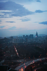 High angle view of city lit up at night