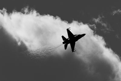 Low angle view of airplane flying in sky