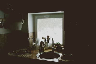 Close-up of washbasin against the window