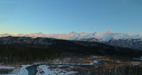 Scenic view of snowcapped mountains against clear blue sky