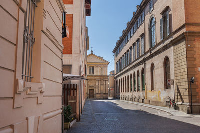 A street in parma and in the background the deconsecrated renaissance church of san marcellino italy