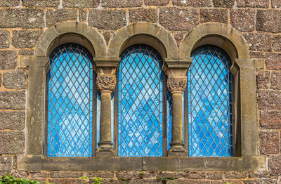 Low angle view of blue window on old building