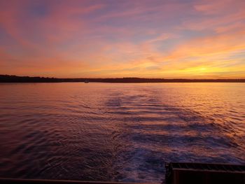 Scenic view of sea against romantic sky at sunset