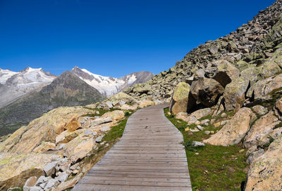 Scenic view of mountains against clear blue sky