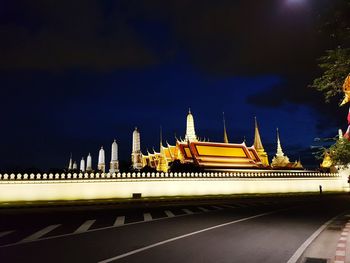 Panoramic view of illuminated building against sky at night