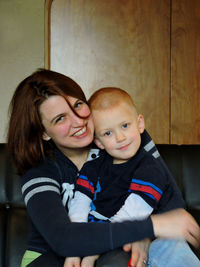 Portrait of happy mother and son at home