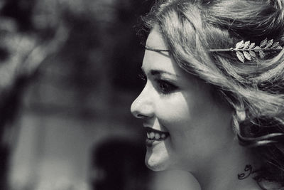 Close-up of young woman wearing tiara while looking away