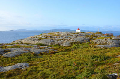 Scenic view of sea and mountain against sky