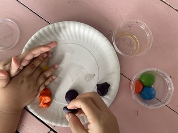 High angle view of woman hand holding glass water