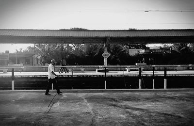 Man playing soccer on field against sky