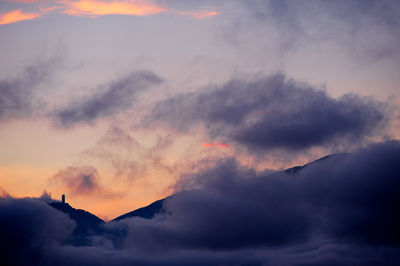 Low angle view of silhouette mountain against dramatic sky