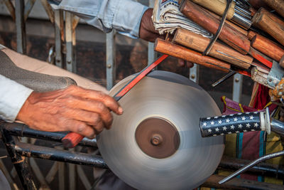 Close-up of man working on machine