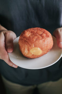 Midsection of woman holding dessert