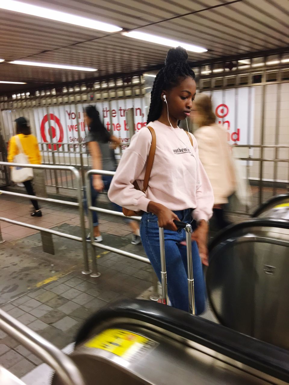 real people, one person, transportation, women, mode of transportation, lifestyles, casual clothing, indoors, three quarter length, blurred motion, motion, public transportation, land vehicle, standing, leisure activity, adult, architecture, looking, hairstyle