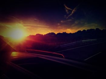 Scenic view of sunset seen through car windshield