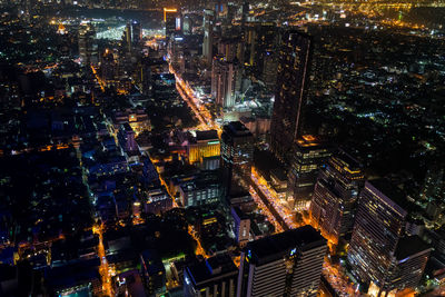 High angle view of city lit up at night