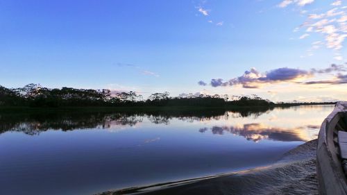 Scenic view of lake against sky at sunset