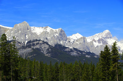 Scenic view of mountains against blue sky