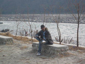 Full length of man sitting on snow