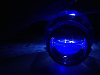 Close-up of illuminated light bulb on table