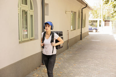 Portrait of young woman standing on street