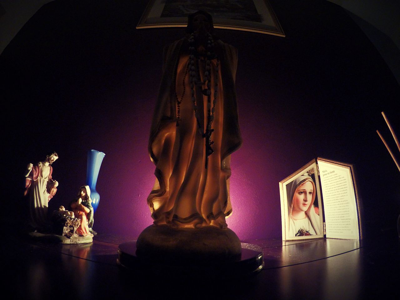 indoors, human representation, art and craft, art, creativity, religion, statue, spirituality, still life, sculpture, decoration, home interior, figurine, candle, table, place of worship, illuminated