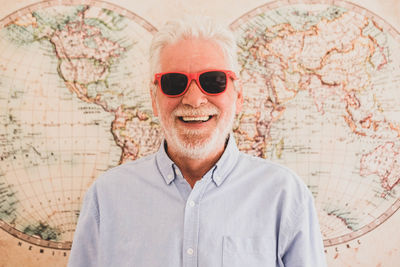 Portrait of smiling man wearing sunglasses standing outdoors