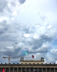 Low angle view of building against cloudy sky