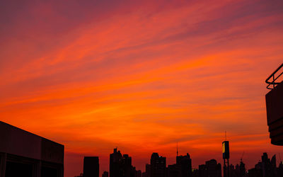 City building in the evening with beautiful red sunset sky and clouds. urban landscape.